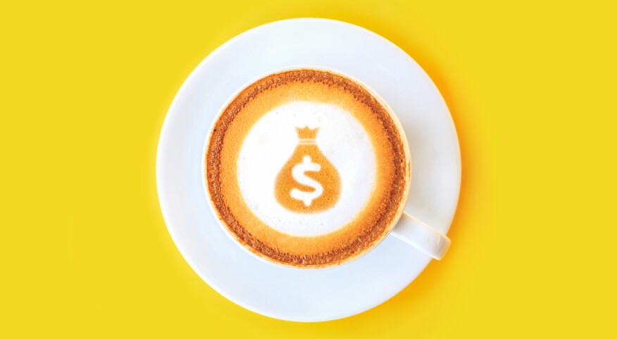 latte with dollar sign and money bag made out of the foam