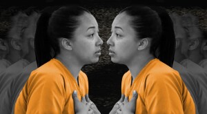 An image of Cyntoia Brown facing herself in an orange prison jumpsuit.