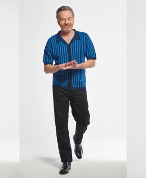 Actor Bryan Cranston in three different poses wearing a blue shirt and black slacks.