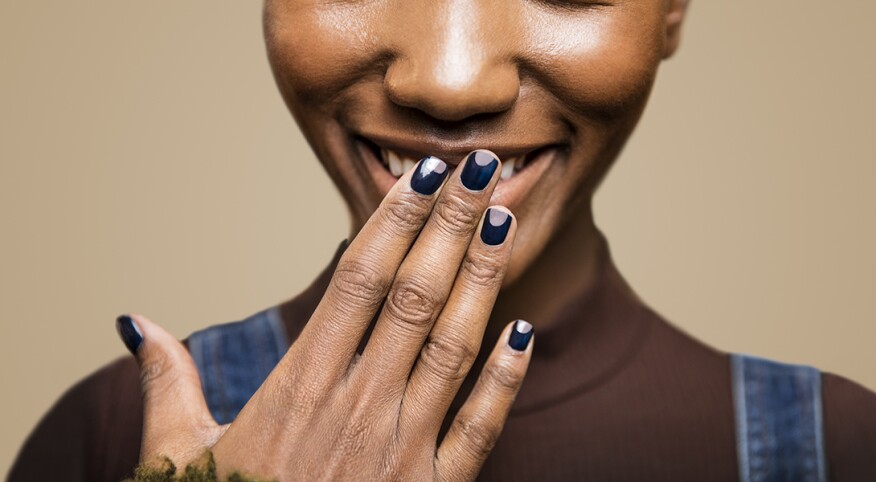 Women with hand in front of her face showing her manicure