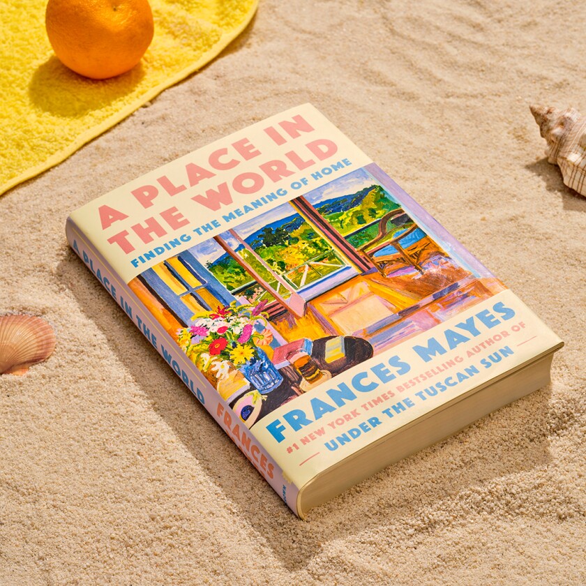 Book styled in the sand with beach accessories