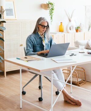 Middle Aged Woman Using Laptop In Home Office