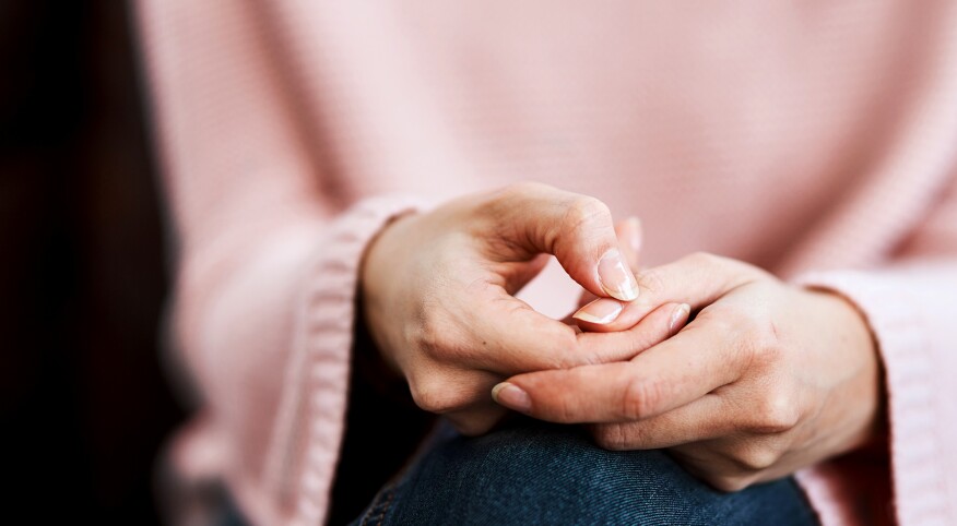 woman wringing her hands with stress