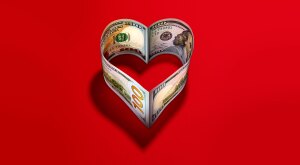 heart made of 100 dollar bills on a red background