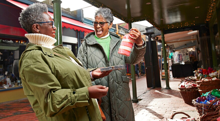 Two woman shopping at an outdoor market