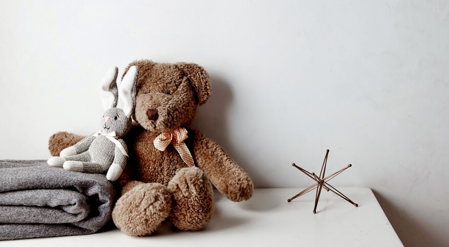 childhood stuffed animals, a bear and a bunny sitting next to each other