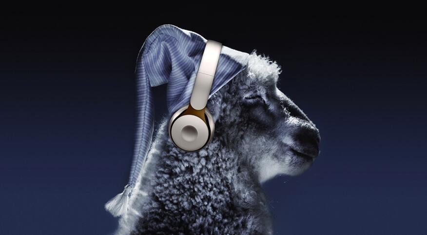 Sheep wearing nightcap and headphones