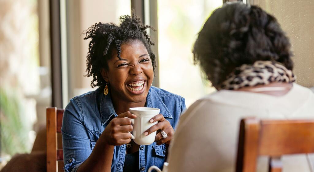 Two women talking over coffee