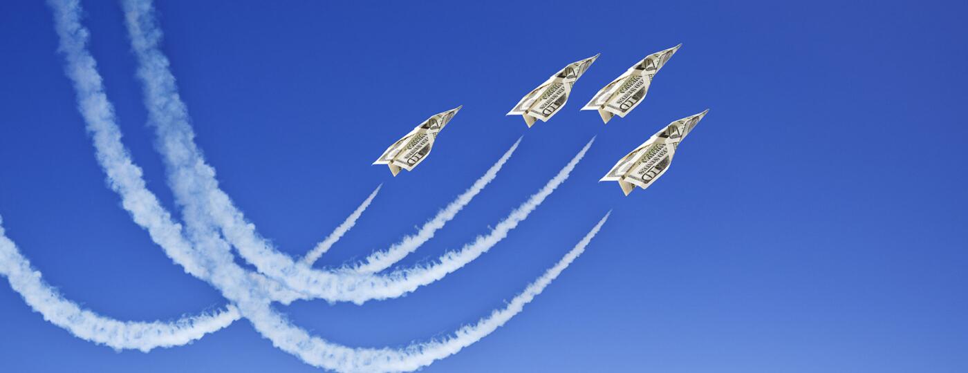 image_of_dollar_bill_paper_airplanes_flying_through_sky_GettyImages-157506556_1800