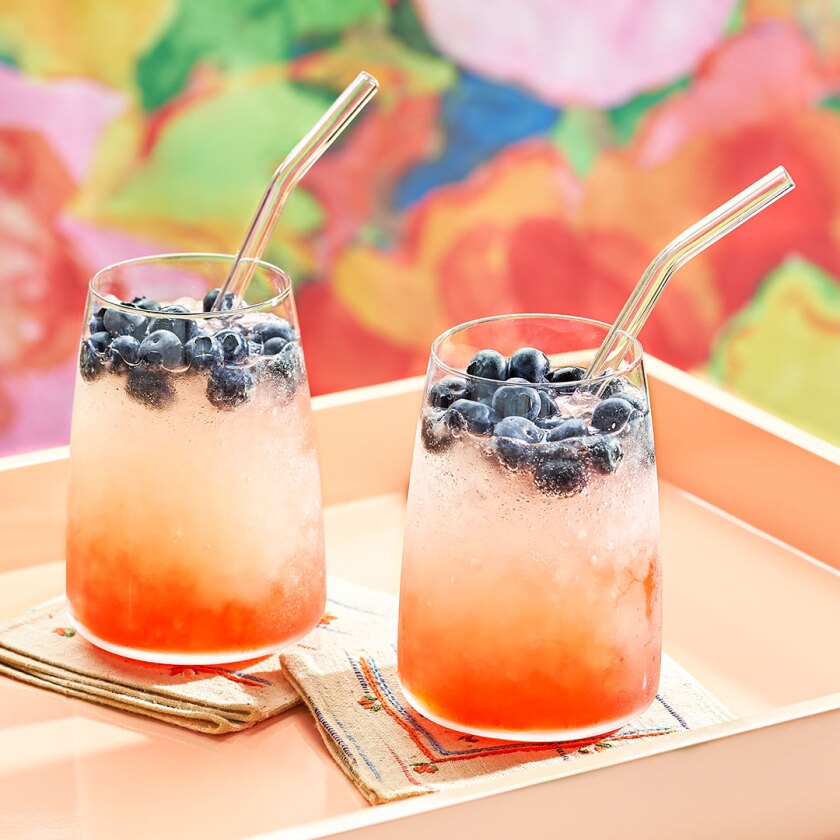 Sunset summer cocktail styled on colorful background