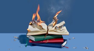 Stack of journals on a blue background with the top pages on fire