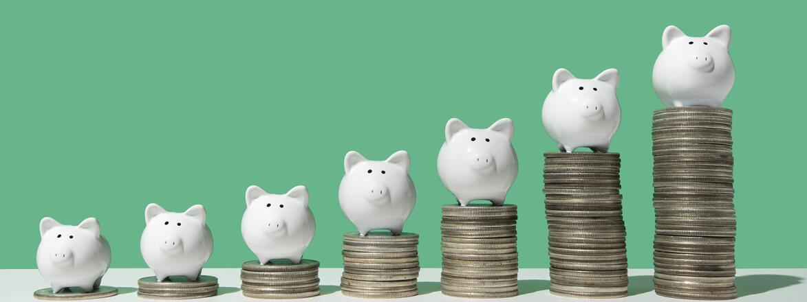 Little piggy banks on ascending stacks of coins