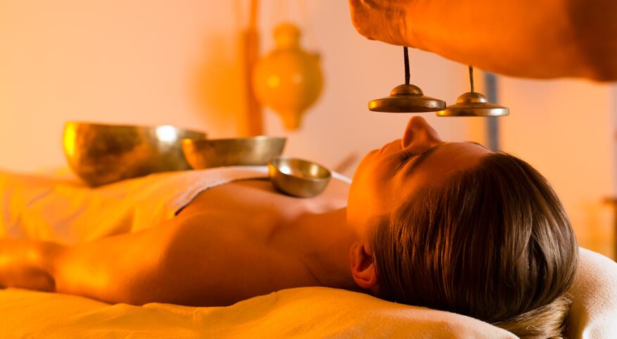 Woman at Wellness massage with singing bowls