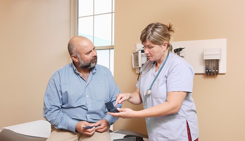 nurse-explaining-diabetic-equipment-to-patient