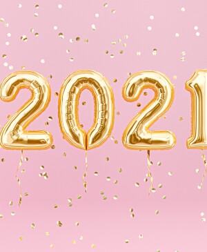 New year 2021 celebration. Gold foil balloons numeral 2021 and confetti on pink background. 3D rendering