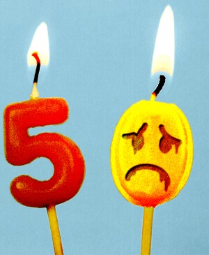 Birthday cake toppers of a 5 and a 0, appearing to melt away with sad face drawn on it