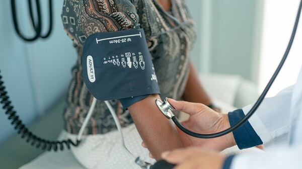 A woman getting her blood pressure checked at a doctor's office