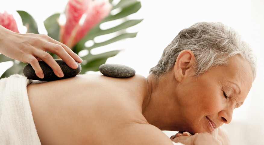 image_of_woman_receiving_hot_stone_massage_GettyImages-146271835_1800