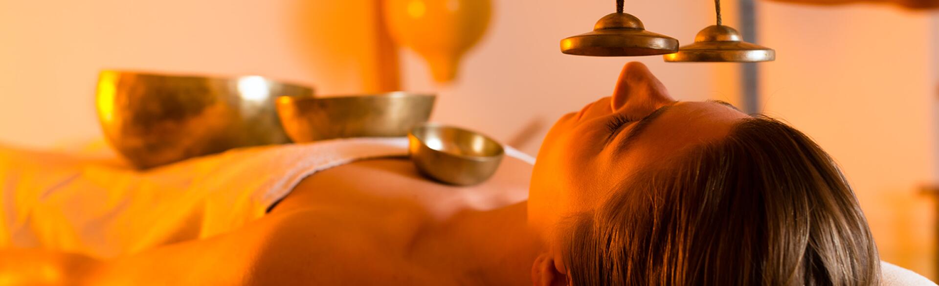 Woman at Wellness massage with singing bowls