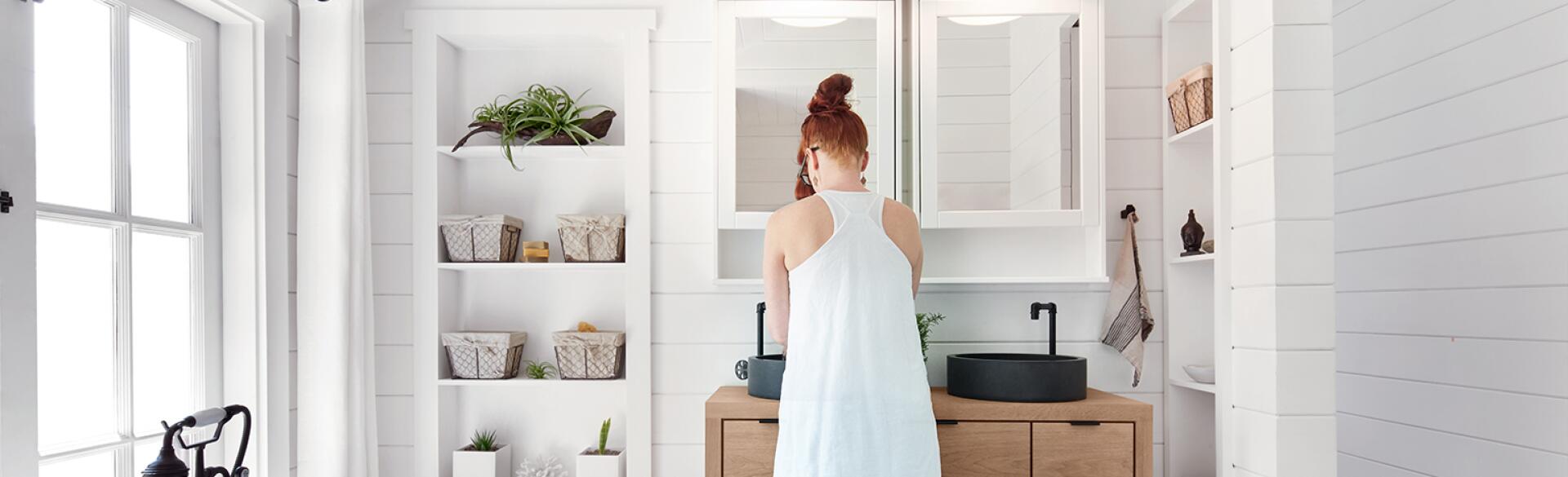 woman washing face while smiling