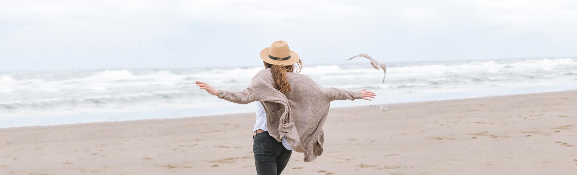 single woman running on the beach