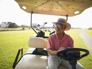 Middle-Aged Man Riding a Golf Cart