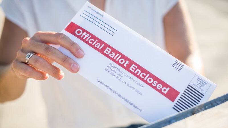 Woman Mailing Her Absentee Voter Ballot